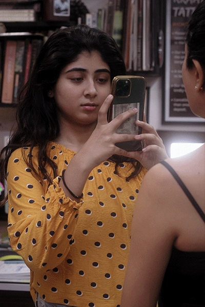 A girl Clicking picture of Tattoo