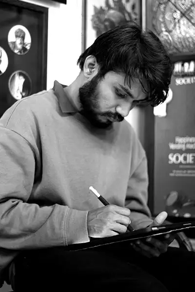 Portrait of tattoo artist Vishal at work in a tattoo studio.